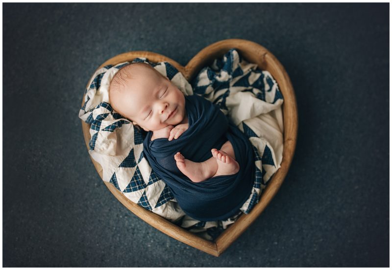 newborn smiling in heart bowl, frisco newborn photographer 