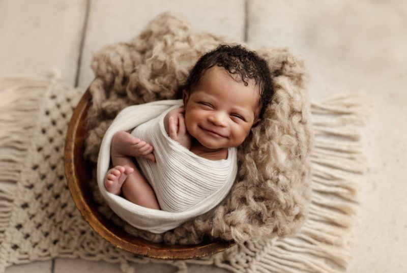 baby smiling in bowl 