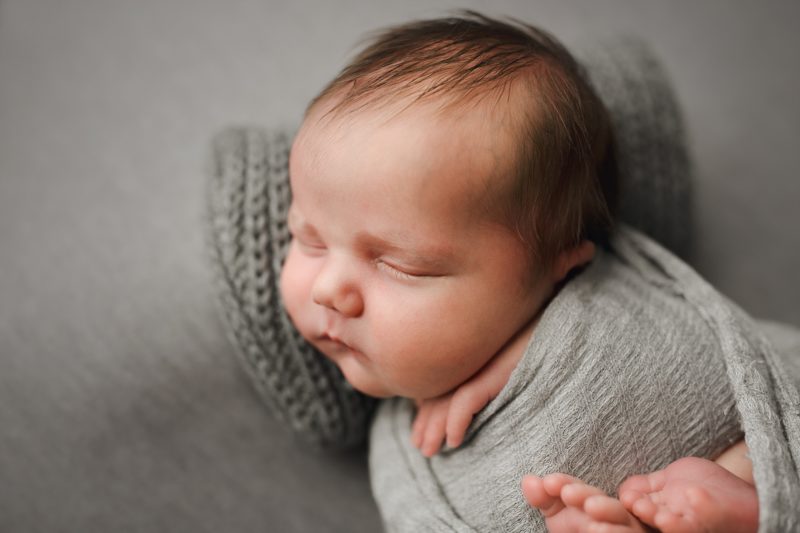 newborn boy swaddled in gray on gray blanket, mckinney newborn photographer