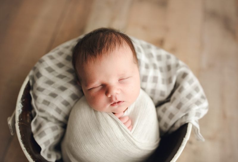 newborn boy swaddled in white in metal bucket, mckinney newborn photographer