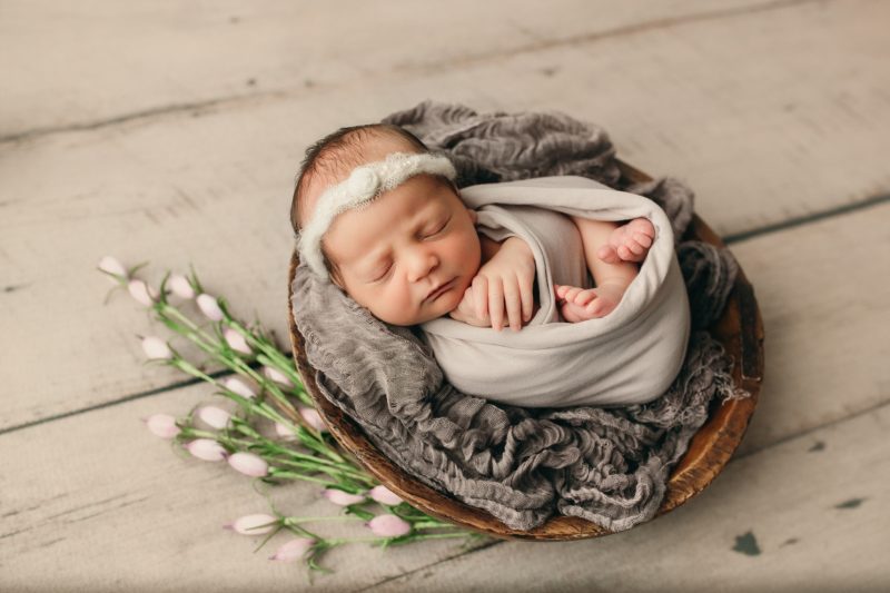 newborn swaddled in basket with flowers, mckinney newborn photos