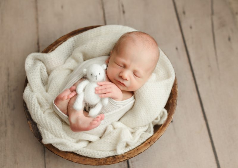 newborn holding baby bear in wooden bowl, prosper newborn photos baby hunter