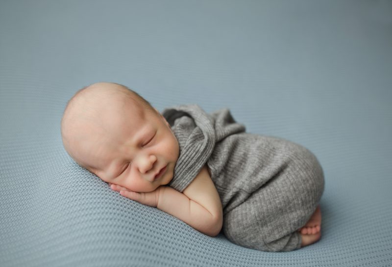 newborn boy wearing gray sweater hoodie, prosper newborn photos baby hunter