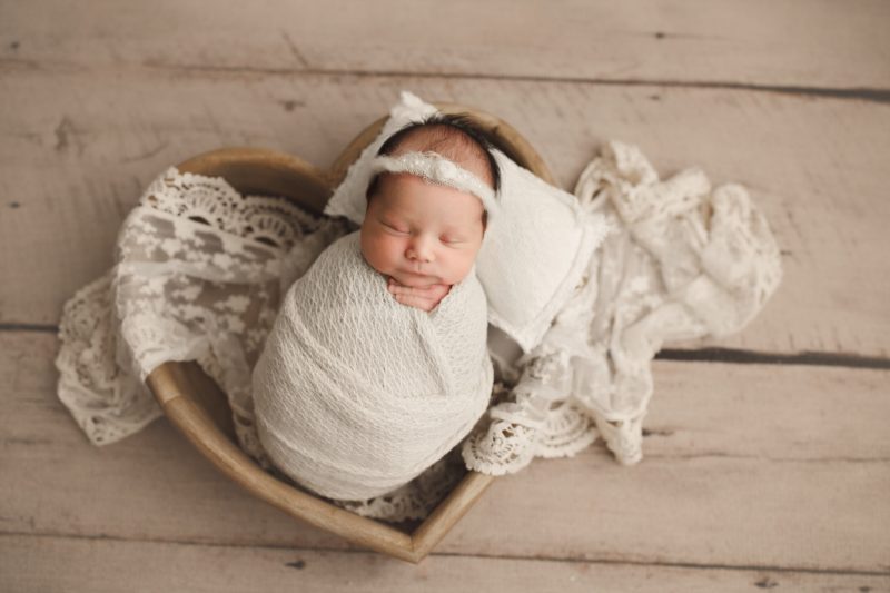 newborn swaddled in white in heart shape wooden box, mckinney newborn photo session baby ada