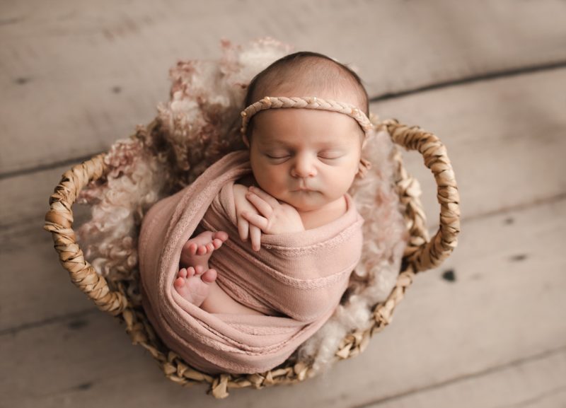 newborn swaddled in pink sleeping in basket, frisco newborn photo session baby livia