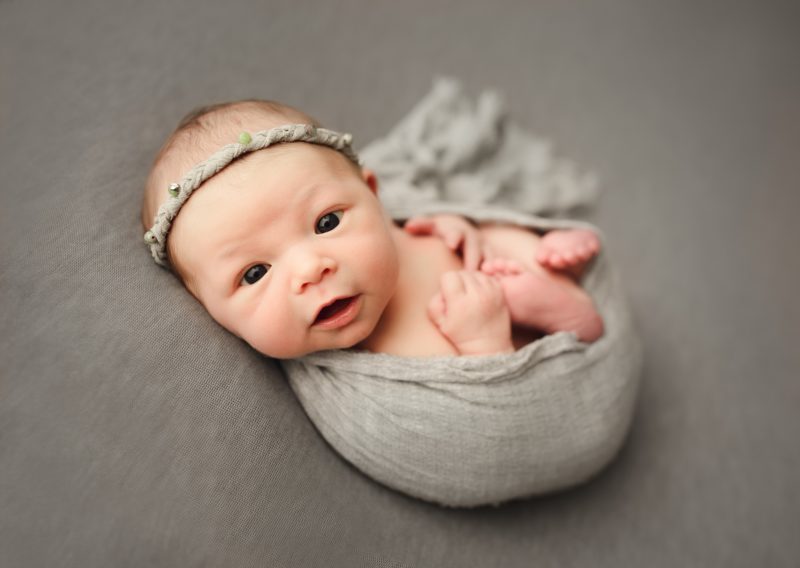 wide awake newborn swaddled in gray on gray blanket, dallas newborn photo session baby mavis