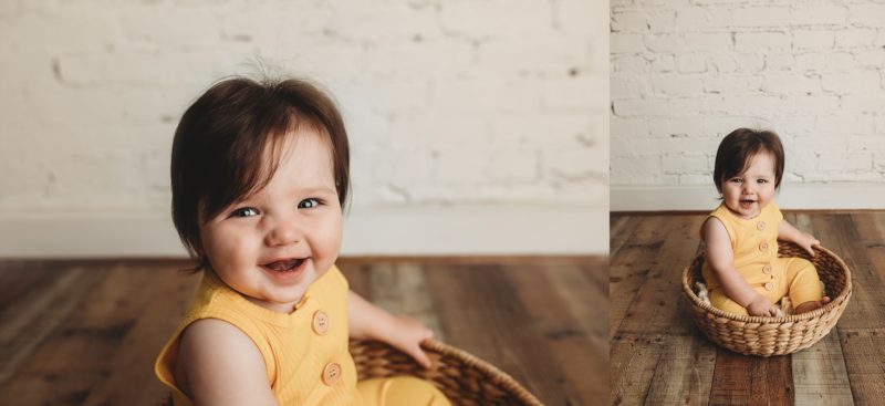 baby sitting up smiling in yellow romper