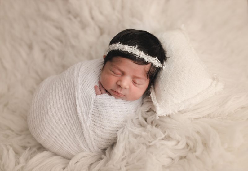 newborn swaddled in white on cream blanket and pillow, mckinney newborn photographer baby jana