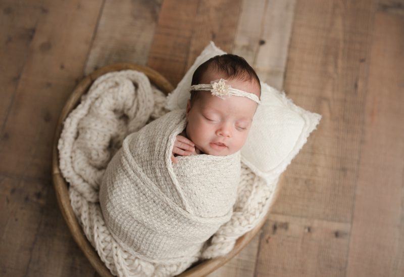newborn swaddled in white laying in heart basket, newborn photo session mckinney, texas