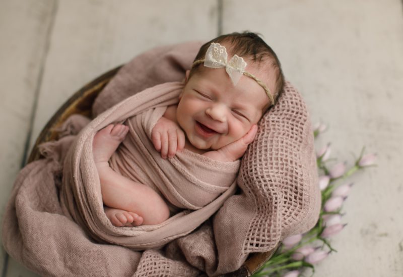 newborn swaddled in pink smiling in bowl, dallas newborn photography session baby giuliana