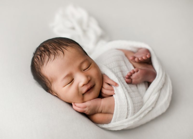 newborn boy swaddled in white on white blanket_mckinney baby photo session baby alex