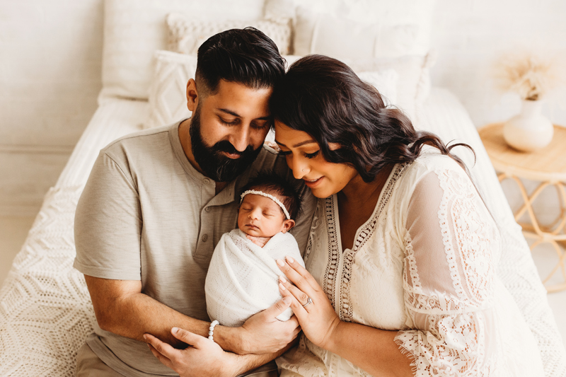 new mom and dad with baby boy during newborn photography session