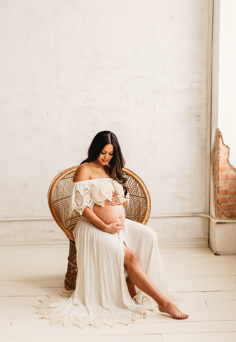 expectant mother sitting in a chair during a maternity session