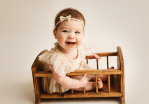 cute baby girl in cradle for sitter session in mckinney, Texas